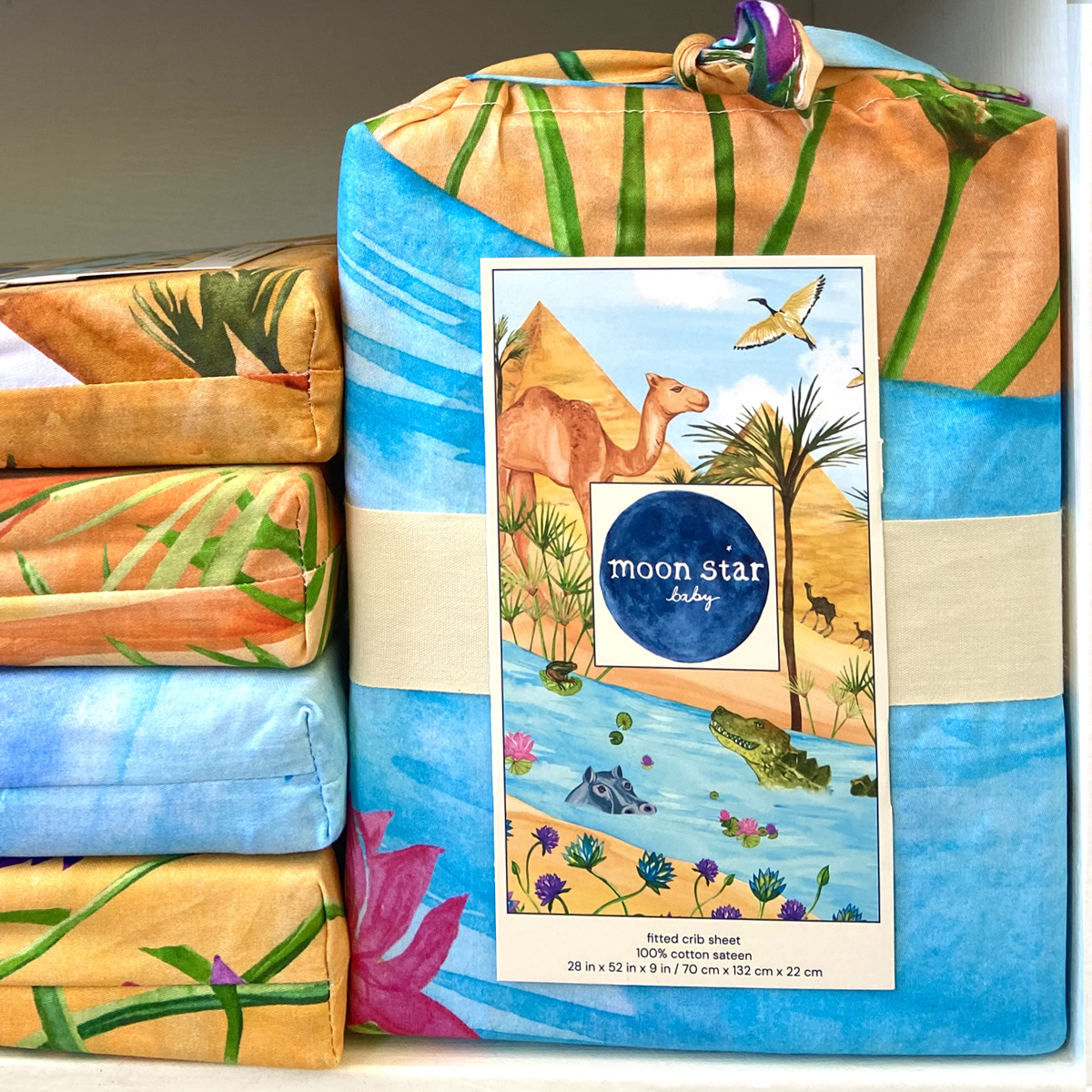 Naptime on the Nile comes folded in a fabric bag made of the same fabric as the sheet so shows portions of the design. A full image of the design in shown on the label.